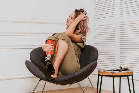 Beautiful young woman with amputation - Pretty and confident woman with leg disability, amputee posing against body shamingの写真素材