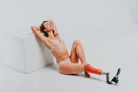 Beautiful young woman with amputation - Pretty and confident woman with leg disability, amputee posing against body shamingの写真素材