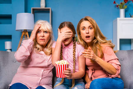 Grandmother, daughter and grandchild together at home, happy domestic life moments - Family having fun, concepts about elderly, mult-generation family and relationshipの写真素材