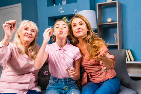 Grandmother, daughter and grandchild together at home, happy domestic life moments - Family having...