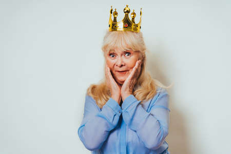 Beautiful senior woman at home and looking at camera smiling - Pretty adult over 60 years old portraitの写真素材