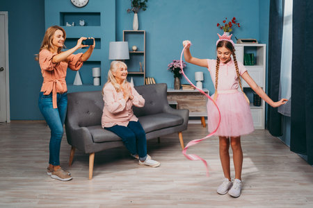 Grandmother, daughter and grandchild together at home, happy domestic life moments - Family having fun, concepts about elderly, mult-generation family and relationshipの写真素材