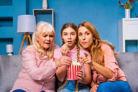 Grandmother, daughter and grandchild together at home, happy domestic life moments - Family having fun, concepts about elderly, mult-generation family and relationshipの写真素材