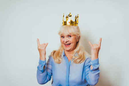 Beautiful senior woman at home and looking at camera smiling - Pretty adult over 60 years old portraitの写真素材