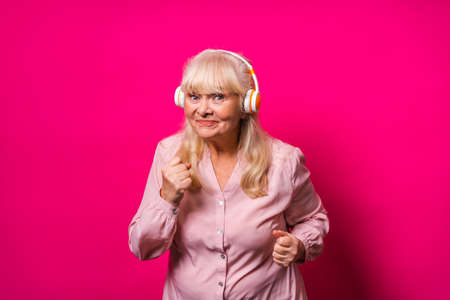 Happy senior woman on colored backgroundの写真素材