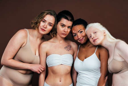 Group of multiethnic women with different kind of skin posing together in studio. Concept about body positivity and self acceptanceの写真素材