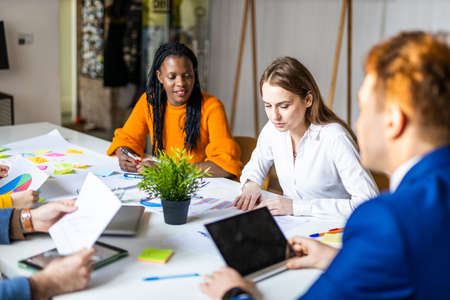 Project managers and employees brainstorming on ideas - Multi-ethnic group of workers having business meeting in a start-up officeの写真素材