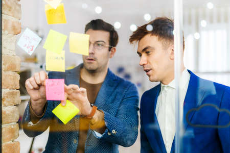 Project managers and employees brainstorming on ideas - Multi-ethnic group of workers having business meeting in a start-up officeの写真素材