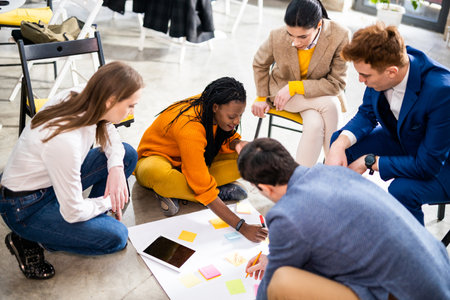 Project managers and employees brainstorming on ideas - Multi-ethnic group of workers having business meeting in a start-up officeの写真素材