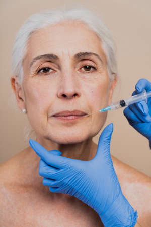Beautiful senior woman with young and clean look, beauty shot - Pretty senior lady over 60 with perfect skin, concepts about elderly, beauty treatment and skin careの写真素材