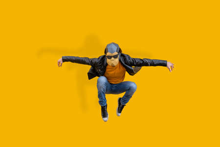 Happy man with funny low poly mask on colored background - Creative conceptual idea for advertising, adult with low-poly origami paper mask doing funny posesの写真素材