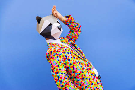 Happy man with funny low poly mask on colored background - Creative conceptual idea for advertising,...