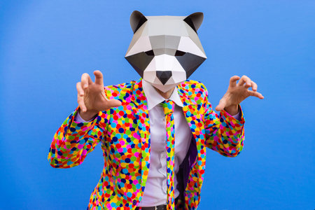 Happy man with funny low poly mask on colored background - Creative conceptual idea for advertising, adult with low-poly origami paper mask doing funny posesの写真素材