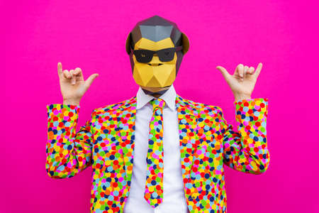 Happy man with funny low poly mask on colored background - Creative conceptual idea for advertising, adult with low-poly origami paper mask doing funny posesの写真素材