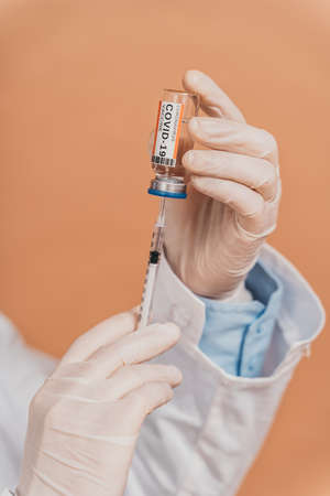 Covid-19 (coronavirus) vaccination campaign in a clinic - People getting vaccinated from doctor and nurse to prevent corona virus outbreak in a vaccination pointの写真素材
