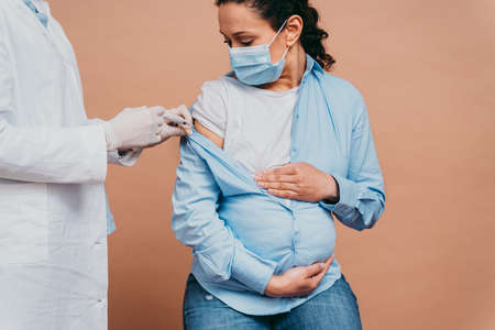 vaccination campaign in a clinic - People getting vaccinated from doctor and nurse to prevent  virus outbreak in a vaccination pointの写真素材