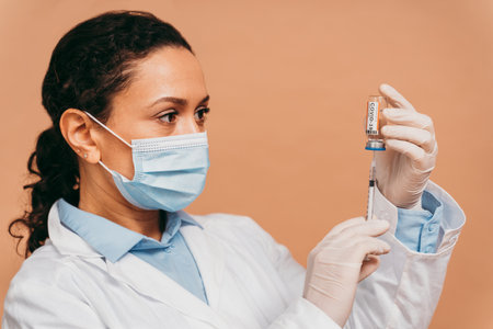 Covid-19 (coronavirus) vaccination campaign in a clinic - People getting vaccinated from doctor and nurse to prevent corona virus outbreak in a vaccination pointの写真素材