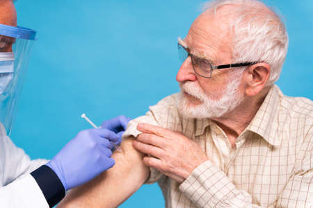 vaccination campaign in a clinic - People getting vaccinated from doctor and nurse to prevent  virus outbreak in a vaccination pointの写真素材