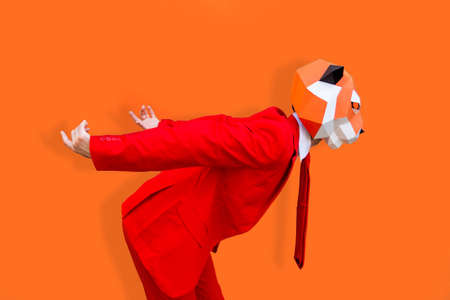 Cool man wearing 3d origami mask with stylish colored clothes - Creative concept for advertising, animal head mask doing funny things on colorful backgroundの写真素材