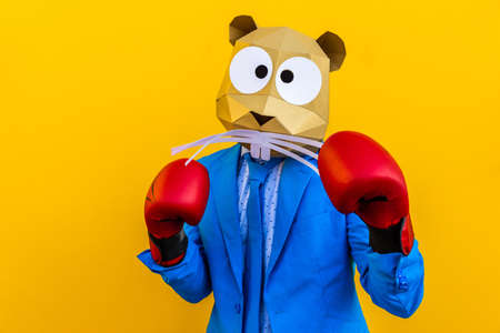 Cool man wearing 3d origami mask with stylish colored clothes - Creative concept for advertising, animal head mask doing funny things on colorful backgroundの写真素材