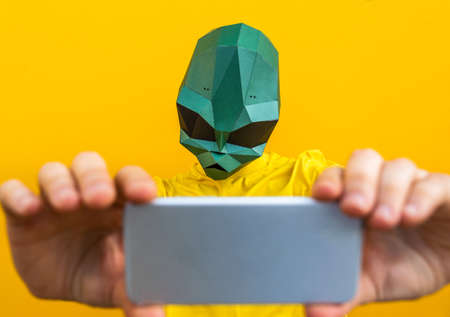 Cool man wearing 3d origami mask with stylish colored clothes - Creative concept for advertising,...