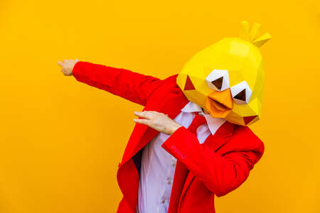 Cool man wearing 3d origami mask with stylish colored clothes - Creative concept for advertising, animal head mask doing funny things on colorful backgroundの写真素材