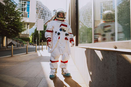 spaceman in a futuristic station. Man with space suit walking in an urban areaの写真素材