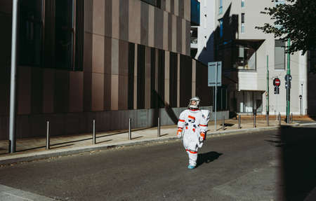 spaceman in a futuristic station. astronaut with space suit walking in an urban area