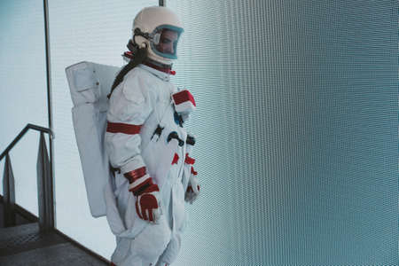 spaceman in a futuristic station. astronaut with space suit walking in an urban areaの写真素材