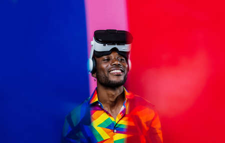 Artistic portrait with gel lights. Handsome man posing on colored backgroundsの写真素材