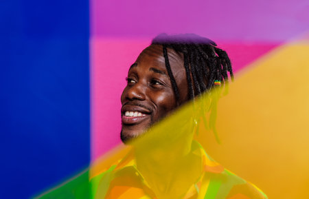 Artistic portrait with gel lights. Handsome man posing on colored backgroundsの写真素材