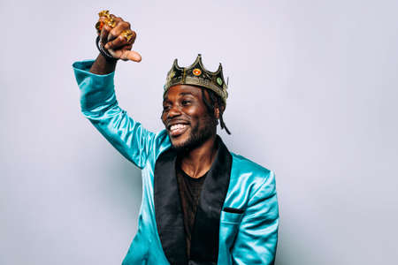 portrait of an hip hop music musician. Cinematic image of a man wearing party clothes and jewels