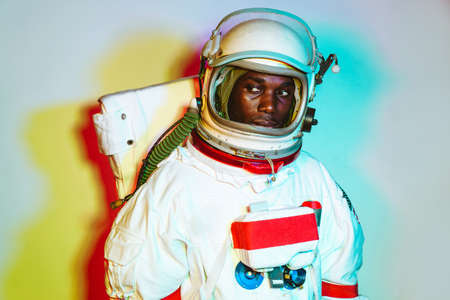 Cinematic image of an astronaut. Colorful portrait of a man with spacesuitの写真素材