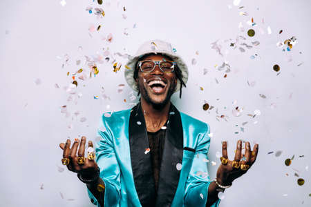 portrait of an hip hop music musician. Cinematic image of a man under confetti dropの写真素材