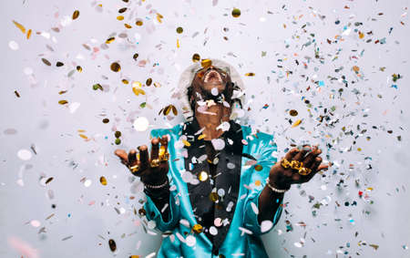 portrait of an hip hop music musician. Cinematic image of a man under confetti dropの写真素材