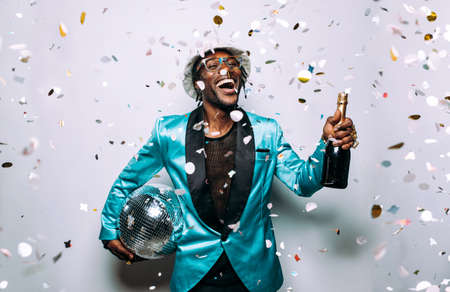 portrait of an hip hop music musician. Cinematic image of a man under confetti drop