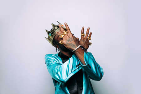 portrait of an hip hop music musician. Cinematic image of a man wearing party clothes and jewelsの写真素材