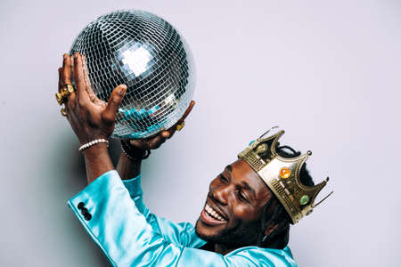 portrait of an hip hop music musician. Cinematic image of a man wearing party clothes and jewels