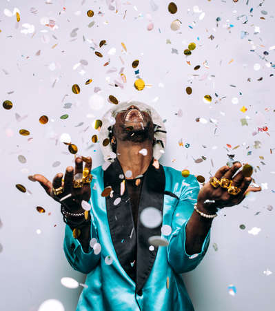 portrait of an hip hop music musician. Cinematic image of a man under confetti dropの写真素材