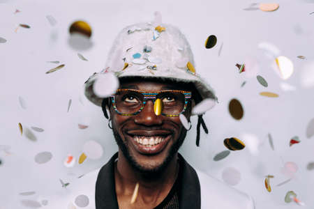 portrait of an hip hop music musician. Cinematic image of a man under confetti dropの写真素材