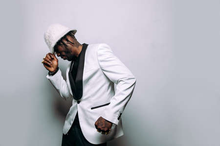 Portrait of an hip hop music musician. Cinematic image of a man wearing white clothes and jewels