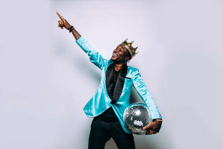 portrait of an hip hop music musician. Cinematic image of a man wearing party clothes and jewelsの写真素材