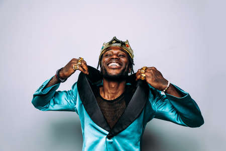 portrait of an hip hop music musician. Cinematic image of a man wearing party clothes and jewelsの写真素材