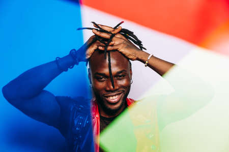 handsome man wearing red leather jacket portrait. Futuristic cyberpunk fashion style. Studio light shot on white backgroundの写真素材