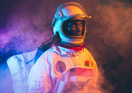 cinematic image of an astronaut. Colorful portrait of a man with spacesuitの写真素材
