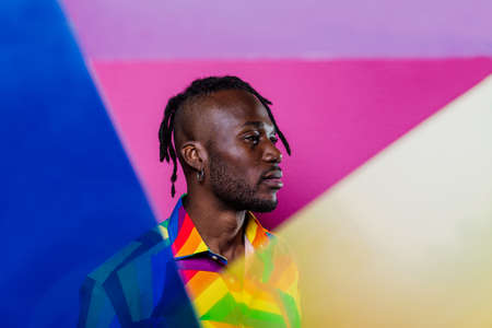 Artistic portrait with gel lights. Handsome man posing on colored backgroundsの写真素材