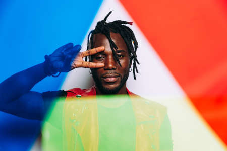 handsome man wearing red leather jacket portrait. Futuristic cyberpunk fashion style. Studio light shot on white backgroundの写真素材