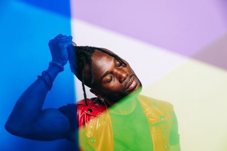 handsome man wearing red leather jacket portrait. Futuristic cyberpunk fashion style. Studio light shot on white backgroundの写真素材