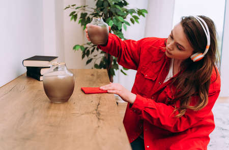 lifestyle moments of a young woman at home. Woman cleaning the apartment up
