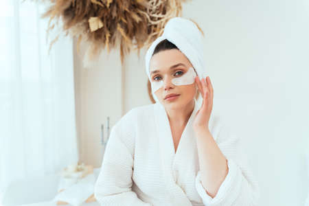 lifestyle moments of a young woman at home. Woman spending time in the bathroom taking care of herselfの写真素材